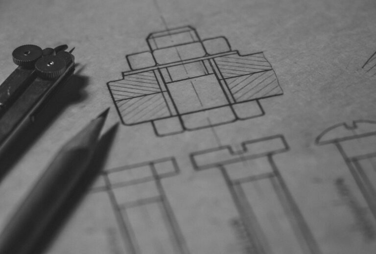 Detailed technical blueprint with pencil and compass illustrating engineering design concepts.